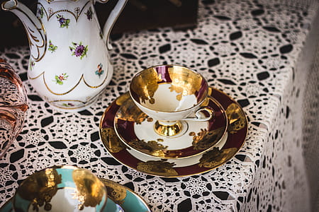 white and brown metal cup on white table sheet thumbnail