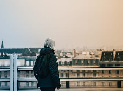 man in black jacket standing on building top during daytime thumbnail