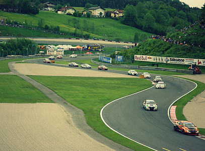 rally cars on pathway surrounded by grass field thumbnail