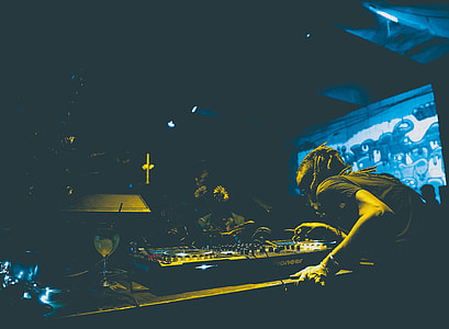 man playing DJ mixer at night time thumbnail