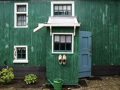 green watering can on ground thumbnail