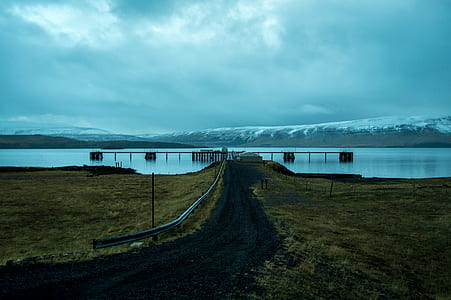 Brown Dock Near Snow Mountain at Daytime thumbnail
