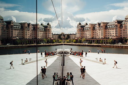 group of persons standing near body of water during daytime thumbnail