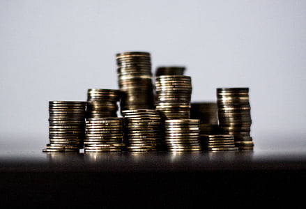 round gold-colored coins in selective focus photography thumbnail