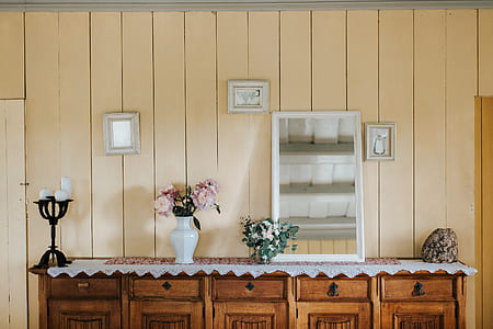 pink petaled flowers centerpiece beside leaning mirror thumbnail