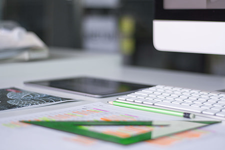 teal pencil near black iPad and iMac thumbnail