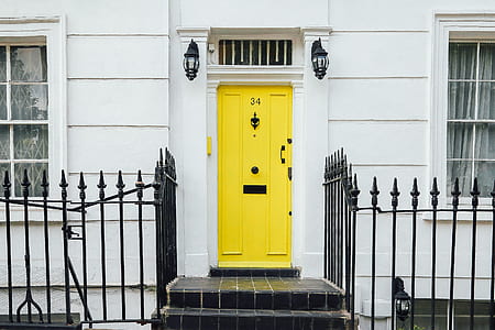 yellow door between steel fences thumbnail