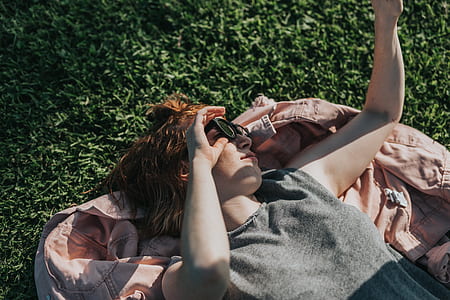 woman lying on maroon textile thumbnail