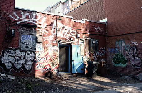 black plastic trash bin in front of building thumbnail