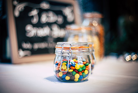 selective focus of clear hermetic jar with multicolored candies thumbnail