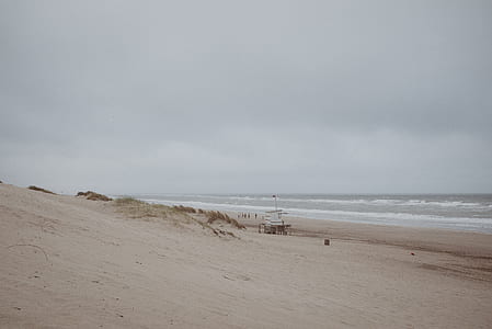 brown sand beach beside sea thumbnail