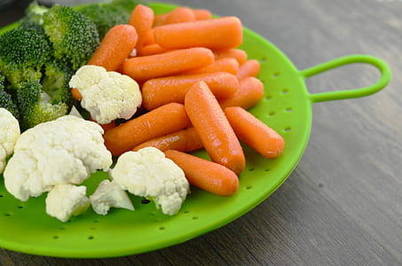broccoli and carrots on green plastic plate thumbnail