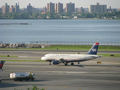 white and blue U.S. Airways plane near river thumbnail