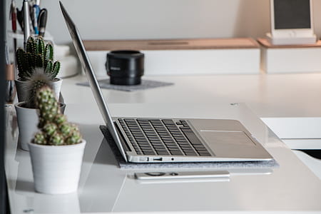 MacBook Air on top of white table inside of white room thumbnail