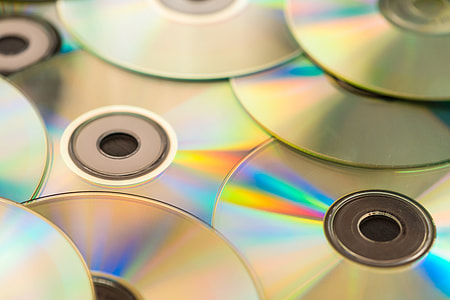 Pile of CD Compact Discs and DVDs thumbnail