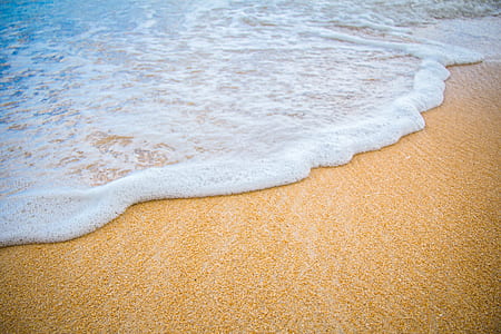 brown seashore with ocean wave during daytime thumbnail
