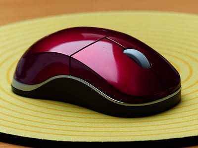 red wireless computer mouse on mouse pad thumbnail