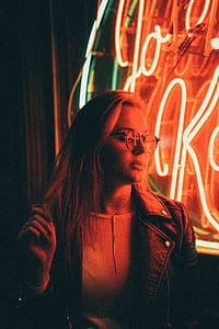 Woman in Denim Jacket Near Neon Signage thumbnail