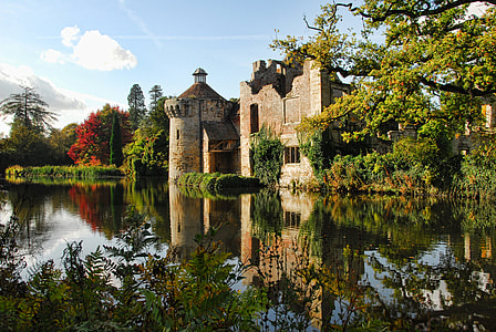 brown castle beside body of water under bright sky thumbnail
