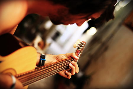 photo of person playing acoustic guitar thumbnail
