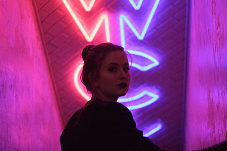 woman standing in front of LED light signage thumbnail