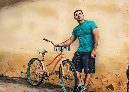 man holding brown cruiser bike thumbnail