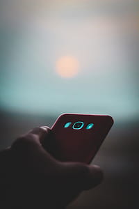 Person Holding White Samsung Android Smartphone With Red Case thumbnail