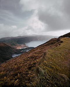 aerial photography of mountain and lake at daytime thumbnail