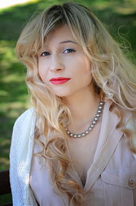woman wearing silver-colored ball link chain necklace close-up photo outdoors thumbnail
