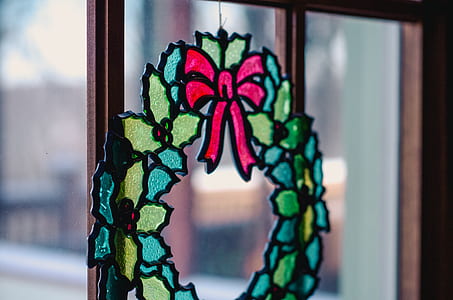 green, yellow, and red stained glass wreath hanged on wall thumbnail
