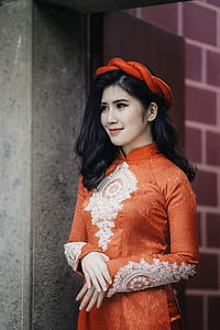 woman wearing orange long-sleeved dress thumbnail