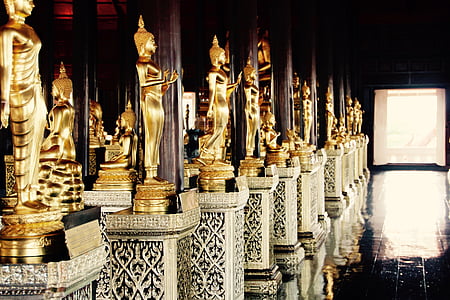 gold-colored Buddha statues inside temple thumbnail