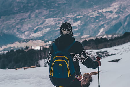 Man in Black and White Jacket and Blue Backpack Doing Snow Ski thumbnail