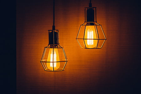 two orange ceiling pendant lamps turned on thumbnail