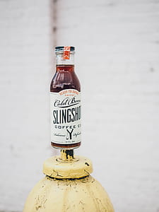 12 fl oz. Cold Brew Slingshot bottle on yellow metal tube thumbnail