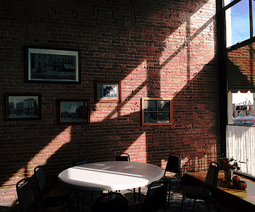 round white table with chairs set near concrete house thumbnail