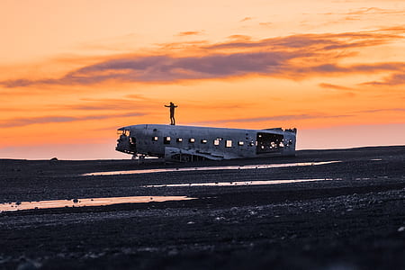 man standing on ship during dawn thumbnail