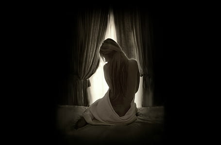 topless woman on bed on dark room thumbnail