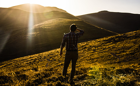 man standing on mountain during daytime thumbnail