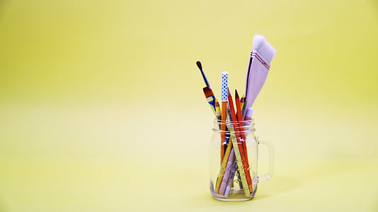 assorted-color pens and pencils in clear glass mason jar thumbnail