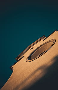 wormseye view of concrete building under blue sky thumbnail