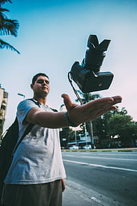 Man Throwing Black Camera in Air thumbnail