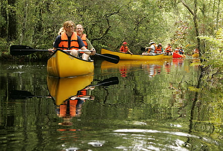 people on canoe rowing on body of water thumbnail