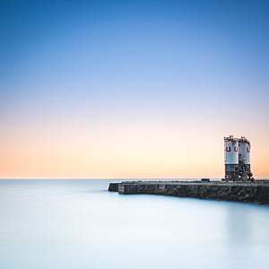 two white powerplant tanks on body of water thumbnail