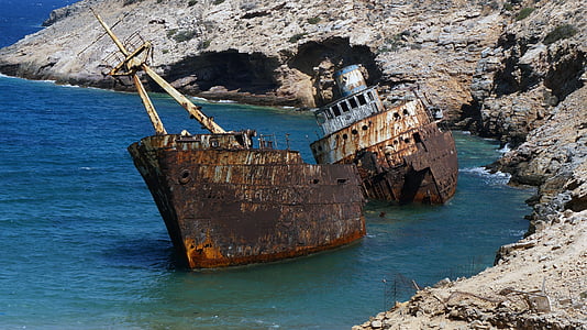 corroded shipwreck docked on body of water thumbnail