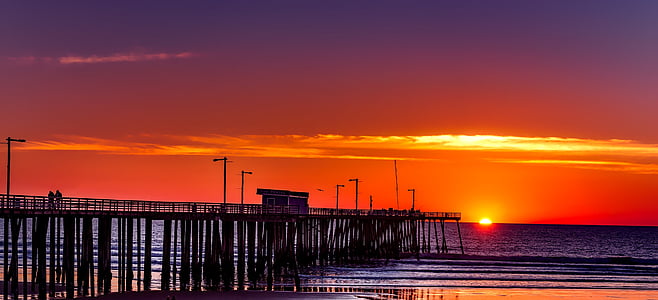 silhouette of shed on dock during golden hour thumbnail