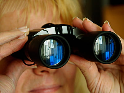 person using black binoculars thumbnail