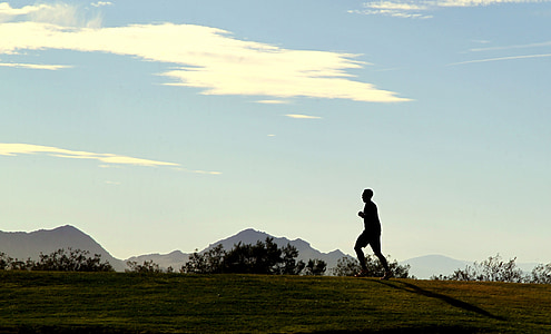 silhouette of man running on top of hill under white clouds at daytime thumbnail