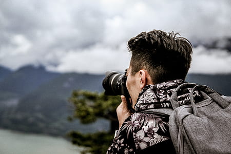 person using camera with backpack thumbnail