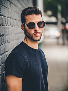man wearing black crew-neck t-shirt and gray framed sunglasses thumbnail